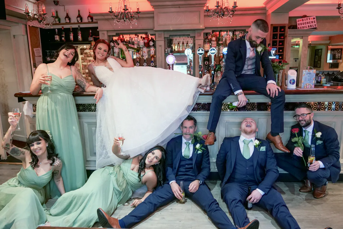 Bridal party having fun together at a bar