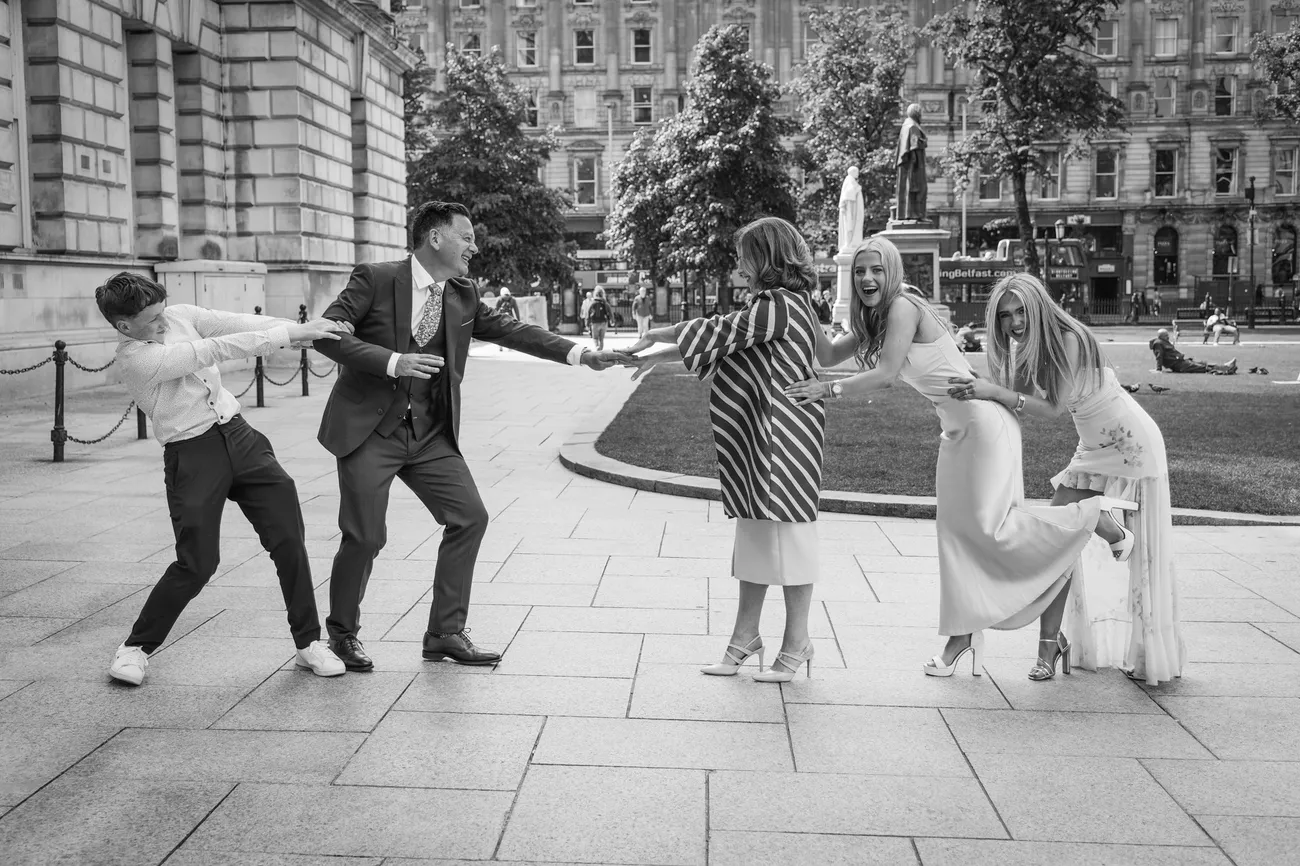 Family having fun outside city hall in black and white