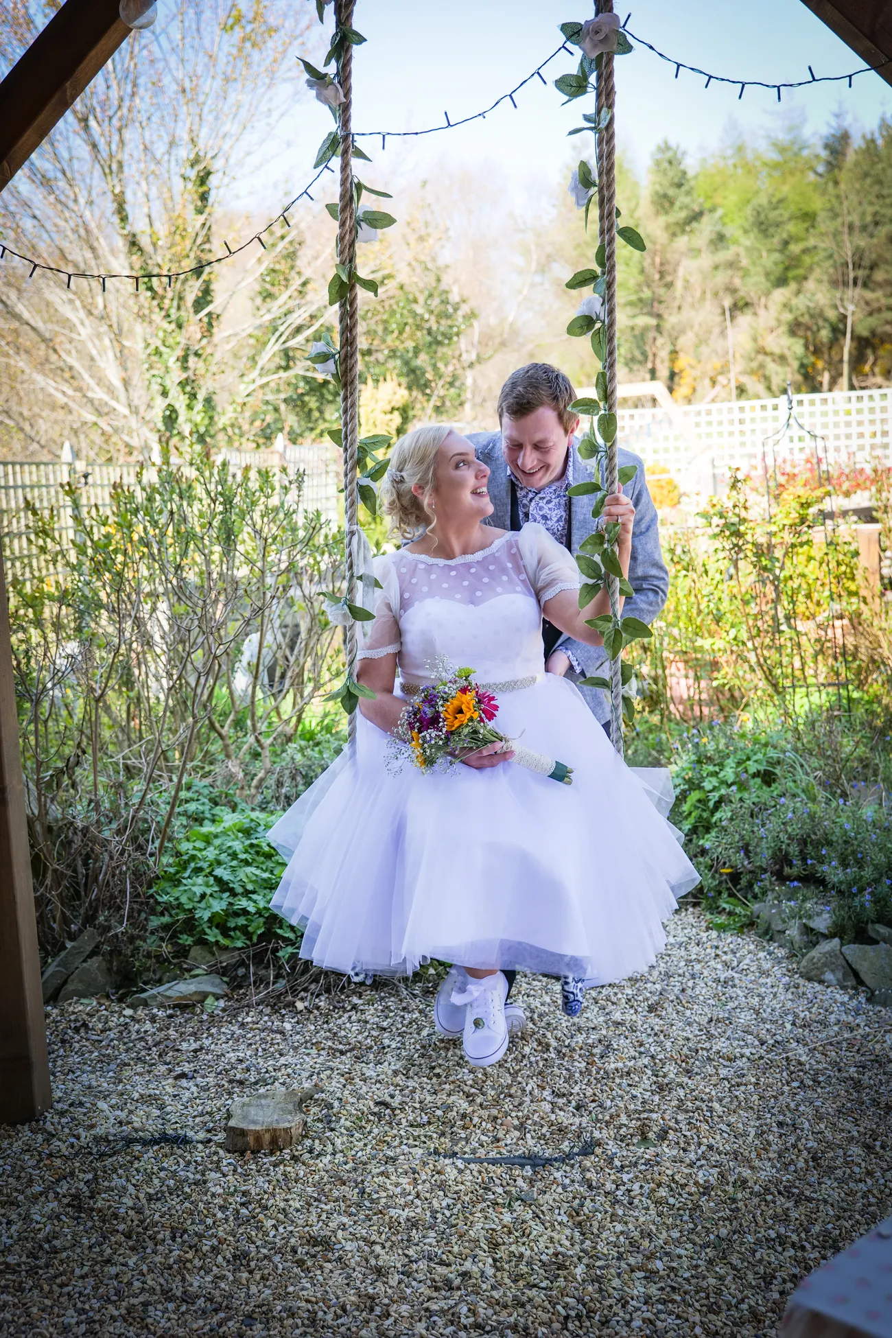 Flower girl walking a garden path at a wedding