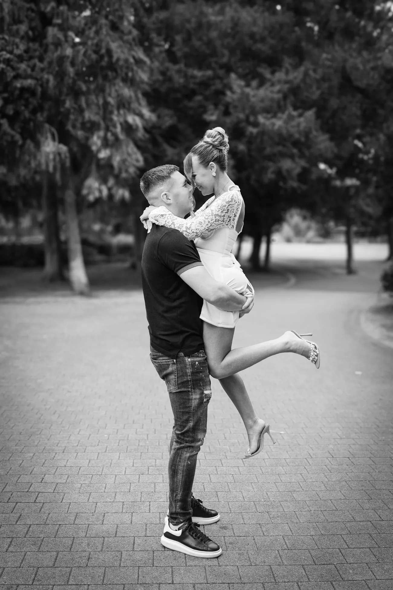 Black and white portrait of a bride lifted in a park