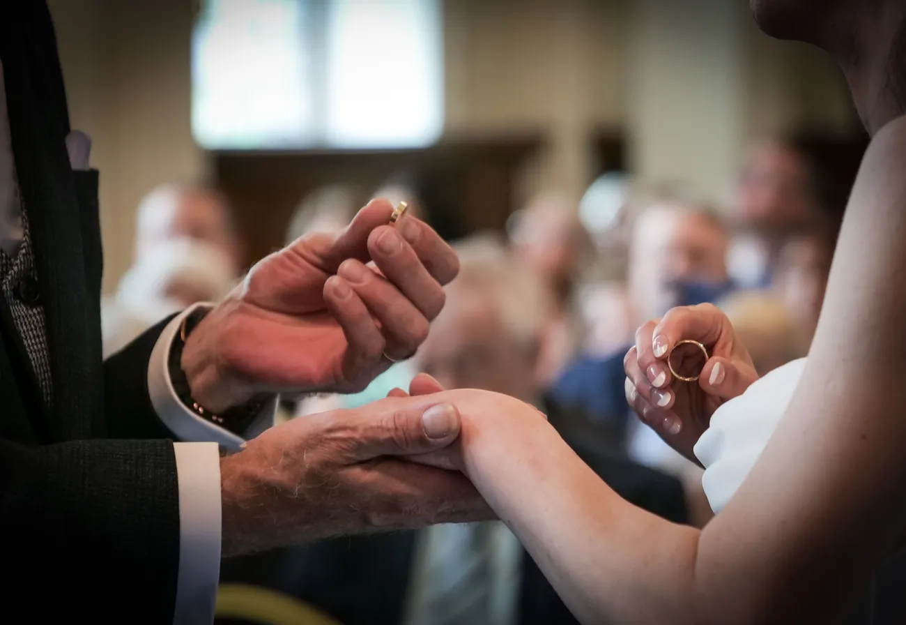 Close-up of a ring exchange during a wedding ceremony