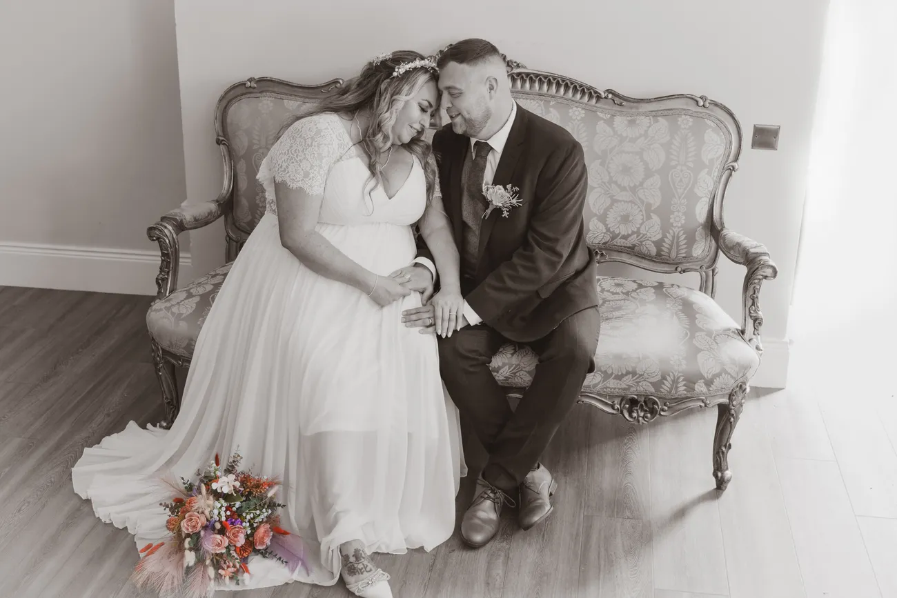 Couple portrait seated on a vintage sofa