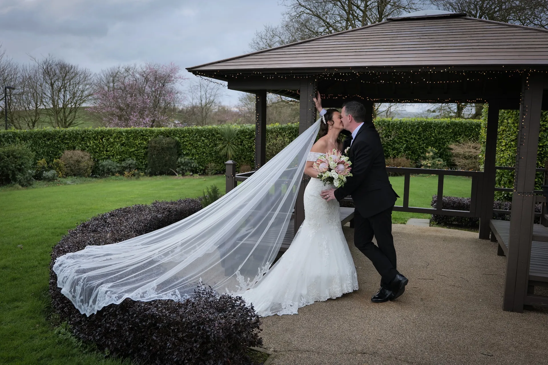 La Mon Hotel wedding photography — couple at the gazebo in the gardens